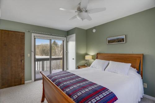 a bedroom with a large bed and a window at Stowe Base Camp 21 in Stowe