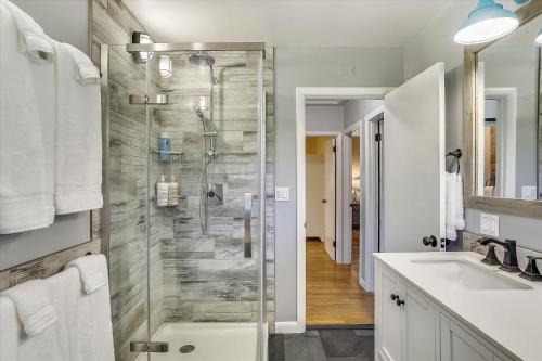 a bathroom with a shower and a sink at Stargazer Cottage in Stowe