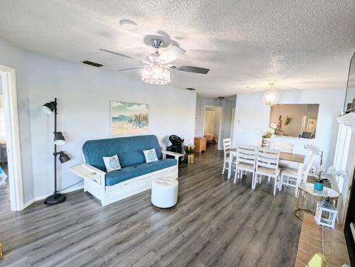 a living room with a couch and a dining room at Lakefront Retreat In Winterset in Winter Haven