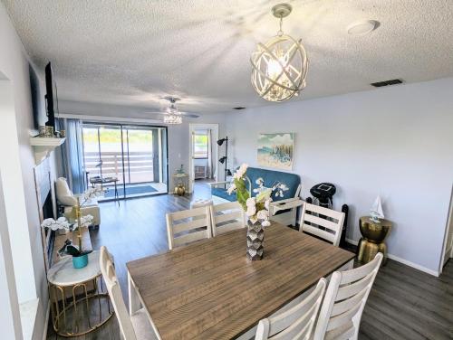 a dining room and living room with a table and chairs at Lakefront Retreat In Winterset in Winter Haven