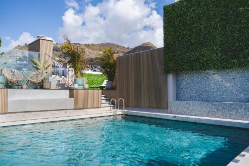 a swimming pool in front of a house at Hotel Taburiente S.C.Tenerife in Santa Cruz de Tenerife