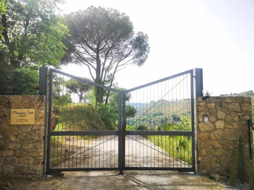 a gate with a view of a field behind it at Panorama Suite in Piazza Armerina