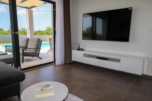 a living room with a tv and a couch at Villa Gemini in Zadar