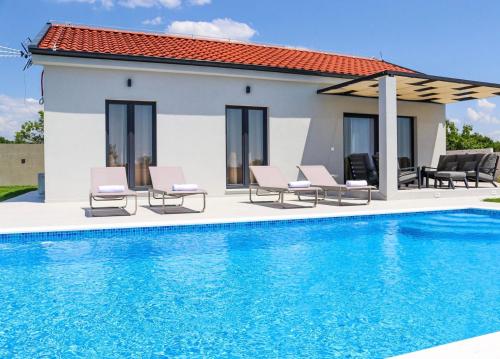 a villa with a swimming pool and a house at Villa Gemini in Zadar