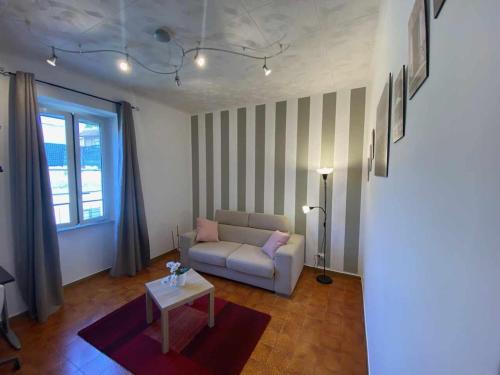 a living room with a couch and a table at Home Romana Centro Nettuno in Nettuno