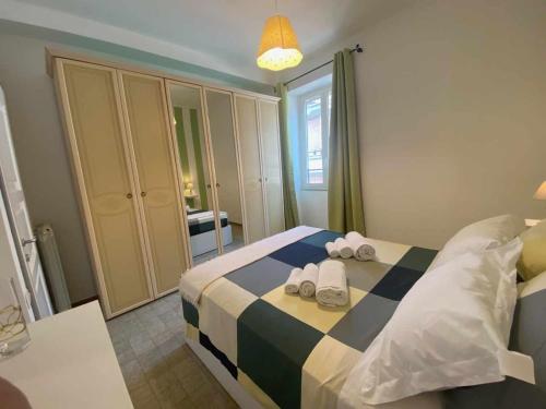 a bedroom with a bed with towels on it at Home Romana Centro Nettuno in Nettuno