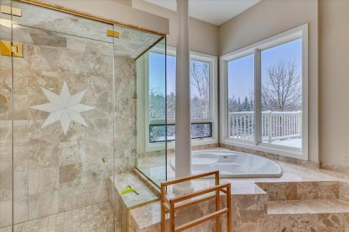 a large bathroom with a tub and a window at Edson Hill Estate in Stowe