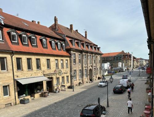 a city street with buildings and cars parked on the street at Wohnung in Bayreuths schönster Straße in Bayreuth