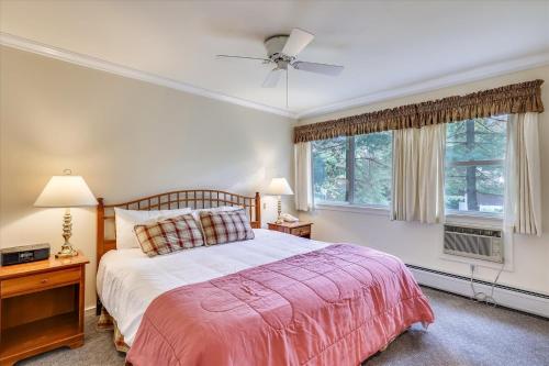 a bedroom with a bed and two windows at Tollhouse 16A in Stowe