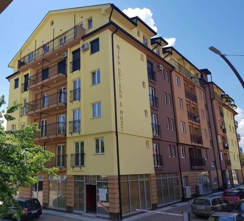 a yellow building on the side of a street at Vesna Apartment in Ohrid