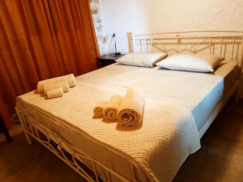 a bedroom with two beds with towels on them at Petrini Villa with swimming pool in Kapparianá