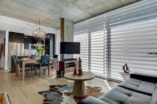 a living room with a couch and a table at Les Immeubles Charlevoix - Le 760-406 in Quebec City
