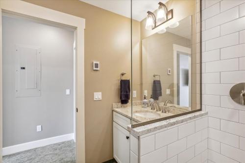 a bathroom with a sink and a large mirror at Trapp Hill View in Stowe