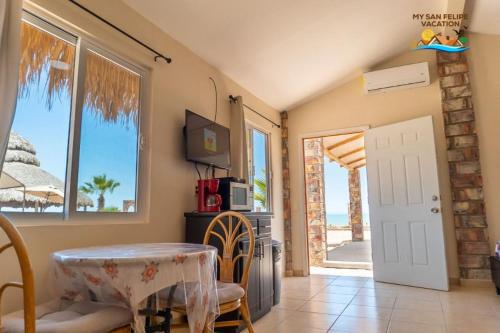 a dining room with a table and a view of the ocean at Ranch Percebu Beach Studio 3 in Don Pancho