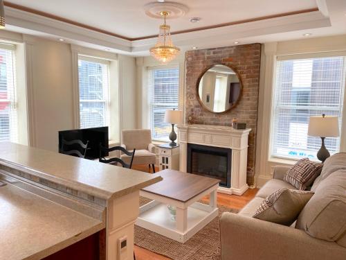 a living room with a couch and a fireplace at Water Street Condos in St. John's