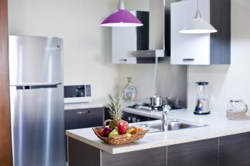 a kitchen with a bowl of fruit on a counter at Costa Esmeralda Village in Palm-Eagle Beach