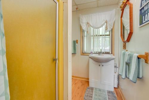 a bathroom with a sink and a mirror at Long Lake Cabin Rental with Private Dock! in Fountain