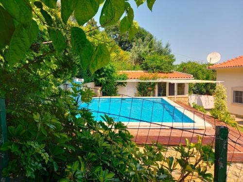 a swimming pool in the backyard of a house at Casa Bianca in Caldas da Rainha
