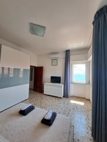 a large bedroom with two beds and a television at Il Balcone sull'Elba in Piombino