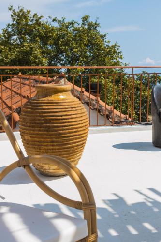 a vase sitting on a chair on a patio at Villa Porta Qeparo in Qeparo