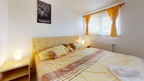 a bedroom with a large bed and a window at Penzion Pod kolem in Šošŭvka