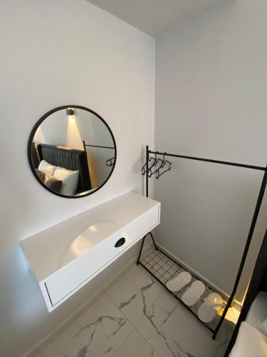 a bathroom with a mirror and a white sink at Bavella Boutique Hotel in Pamukkale