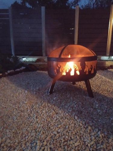 a fire pit sitting in a yard at night at Nikos' Home in Gastourion