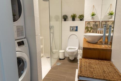 uma casa de banho com um WC, um lavatório e uma máquina de lavar roupa em Jack&Lily's em Évora