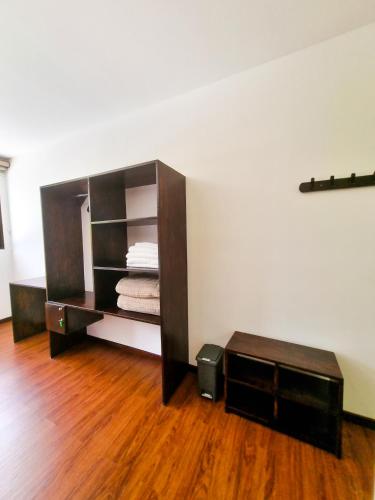 a room with a shelf and a wooden floor at Burbi Lake Lodge Monteverde in Monteverde Costa Rica