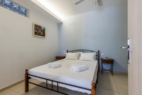 a bedroom with a bed with two towels on it at Elios Cozy Apartment in Neo Klima