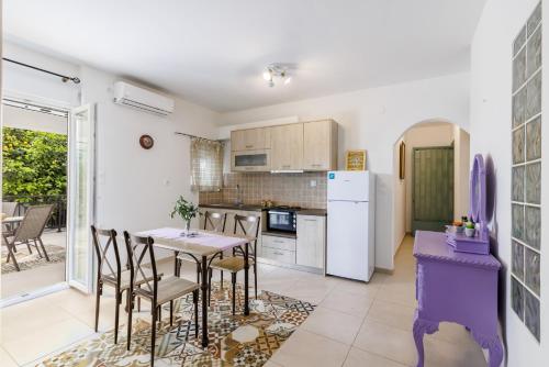 a kitchen and dining room with a table and chairs at Elios Cozy Apartment in Neo Klima