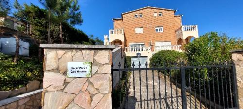 a gate to a house with a sign on it at Bravaholidays-601-Lloret Park 1 in Vidreres