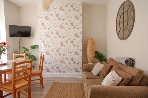 a living room with a couch and a table at Welcoming 4 Bed Holiday Home in Eastbourne in Eastbourne