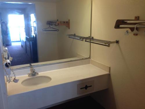 a bathroom with a sink and a mirror at Sky Suites in Tybee Island
