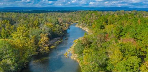 an aerial view of a river in a forest at Hickory Bear - Cabin surrounded by pines, Sleeps 10, Hot Tub, Fire Pit, Arcade, Foosball Table & Deck Slide in Broken Bow