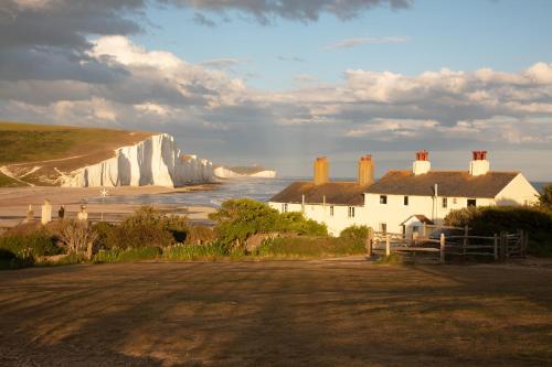 Welcoming 4 Bed Holiday Home in Eastbourne في إيستبورن: إطلالة على المنحدرات البيضاء والمحيط مع منزل