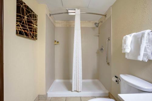 a bathroom with a shower and a toilet and a sink at Best Western Plus Jonesboro Inn & Suites in Jonesboro