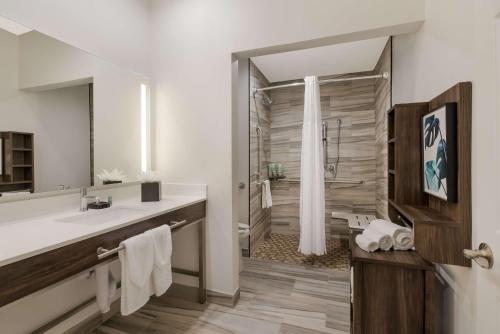 a bathroom with a sink and a shower at Best Western La Place Inn in Laplace