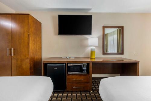 a hotel room with a desk with a tv on the wall at Comfort Inn Downtown Nashville - Music City Center in Nashville
