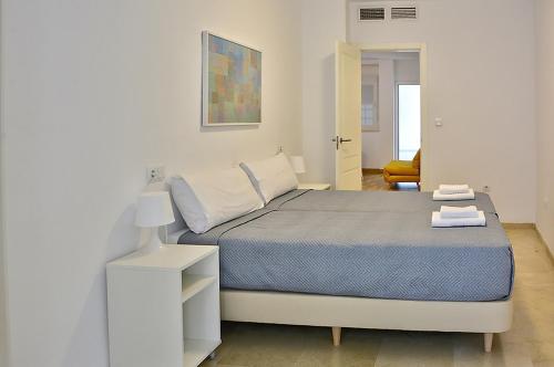 1 dormitorio blanco con 1 cama y armario blanco en Exclusivo Apartamento en el Centro de Sevilla, en Sevilla