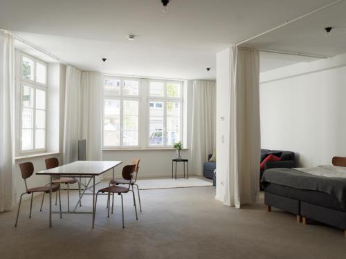 a bedroom with a bed and a table and chairs at KAJO269 FERIENcc WOHNUNGEN IN DER ALTSTADT in Freiburg im Breisgau