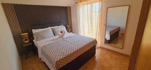 a small bedroom with a bed and a mirror at Gimy Villa&App 2 Porec in Nova Vas