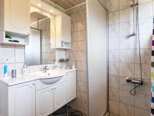 a bathroom with a sink and a shower at Two-Bedroom Holiday home in Thyholm 4 in Sindrup
