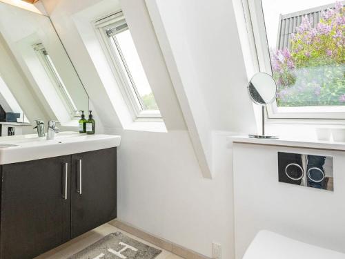 a bathroom with a sink and a window at Golf & Spa Retreat - By Traum Ferienwohnungen in Farsø