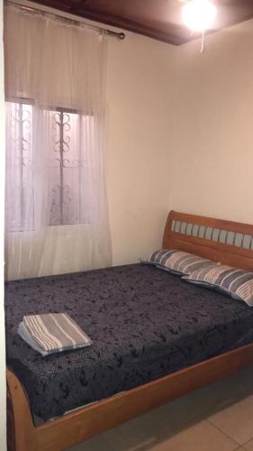 a bed in a room with a window and a mattress at Yazmin Studio Residence in Lamin
