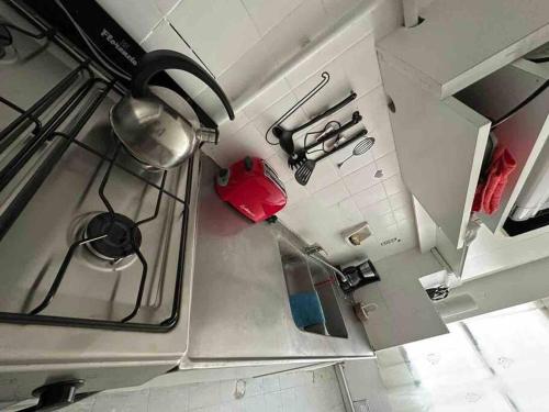 a kitchen with a stove top with a pot on it at Depto Impecable con Cochera in Azul