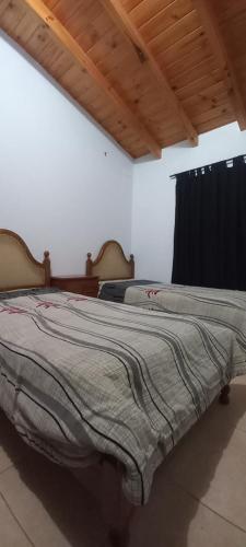 a bedroom with two beds and a black curtain at Chesca- Piso de categoria in San Juan