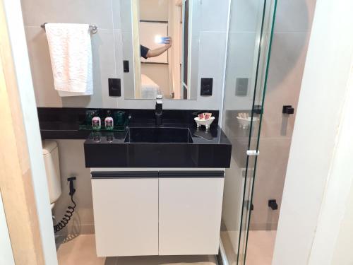 a bathroom with a sink and a mirror at Apartamento na Barra da Tijuca in Rio de Janeiro