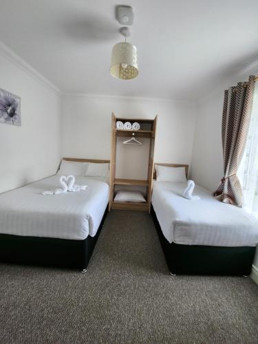 two beds in a hotel room withskirts at Park View room with free minibar tea&coffee in Dublin
