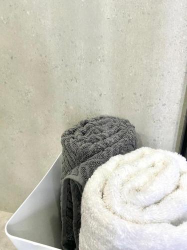 a pile of towels sitting on top of a table at 63 Lodging Villa in Rustenburg